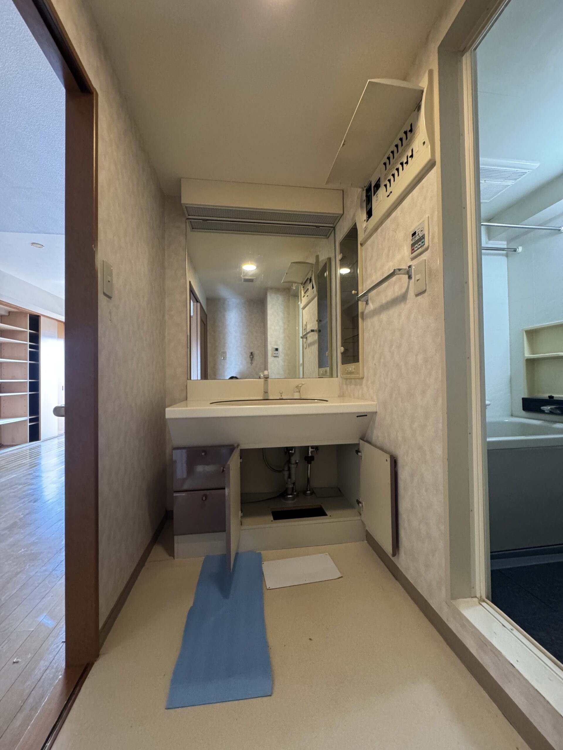 リビング・玄関に施工したエコカラットを間接照明で照らし、ホテルライクな空間を演出。モノトーン基調の内装に、ブラウンやブルーのクロスをアクセントとして採用した、施主様こだわりのお部屋。